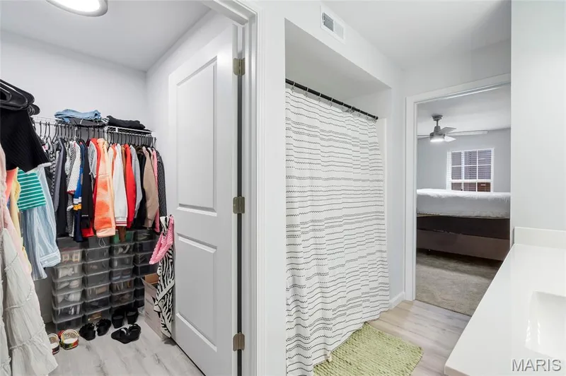 Designed for everyday ease, this private suite layout links the sleeping quarters, a spacious full bath, and a deep walk-in closet with built-in shelving. — 4101 Spring Creek Lane, O'Fallon, MO 63368