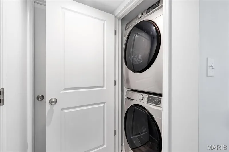 In-unit laundry closet comes equipped with a modern, space-saving stacked washer and dryer set. — 4101 Spring Creek Lane, O'Fallon, MO 63368
