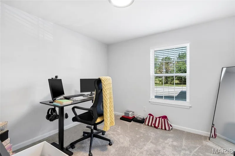 This versatile secondary bedroom is filled with natural light, perfect for setting up a quiet home office, study space, or guest room. — 4101 Spring Creek Lane, O'Fallon, MO 63368