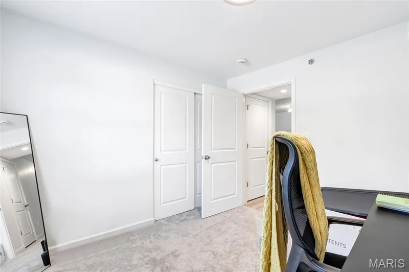 Brand-new, neutral carpeting and walls create a clean canvas in this secondary room, complete with a closet and smooth access to the hallway. — 4101 Spring Creek Lane, O'Fallon, MO 63368