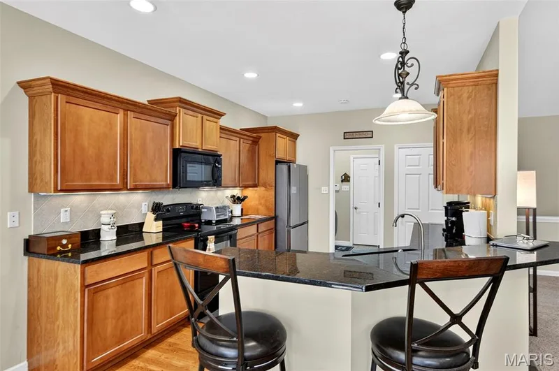 Breakfast Bar with Granite overhang — 18 Eagle Bluff Lane, St Charles, MO 63303