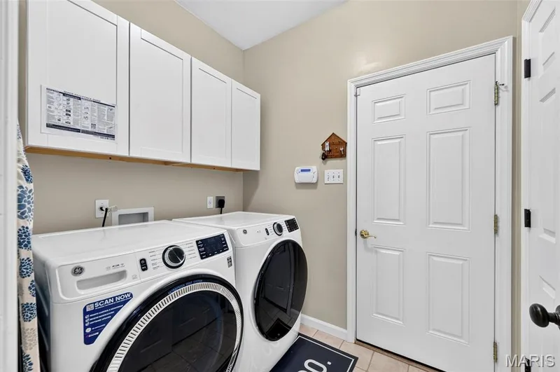 LaundryRoom w/Closet & Cabinetry.  Washer &  Dryer is included — 18 Eagle Bluff Lane, St Charles, MO 63303