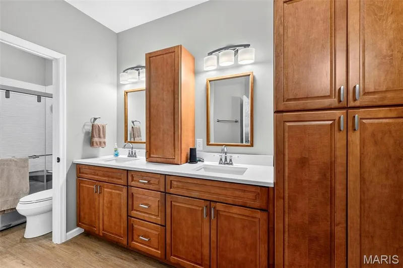 Updated Bath with Linen Cabinetry, Quartz Counters & Dual Sinks — 18 Eagle Bluff Lane, St Charles, MO 63303