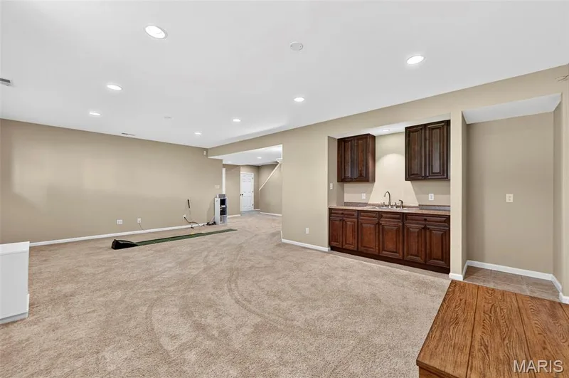 Spacious Family Room w/Webar, Cabinetry and dedicated space for a Refrigerator. — 18 Eagle Bluff Lane, St Charles, MO 63303
