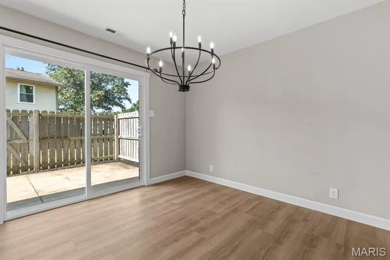 Breakfast room features new lighting and new sliding glass door leading to a large patio — 39 Park Charles Boulevard S #D, St Peters, MO 63376