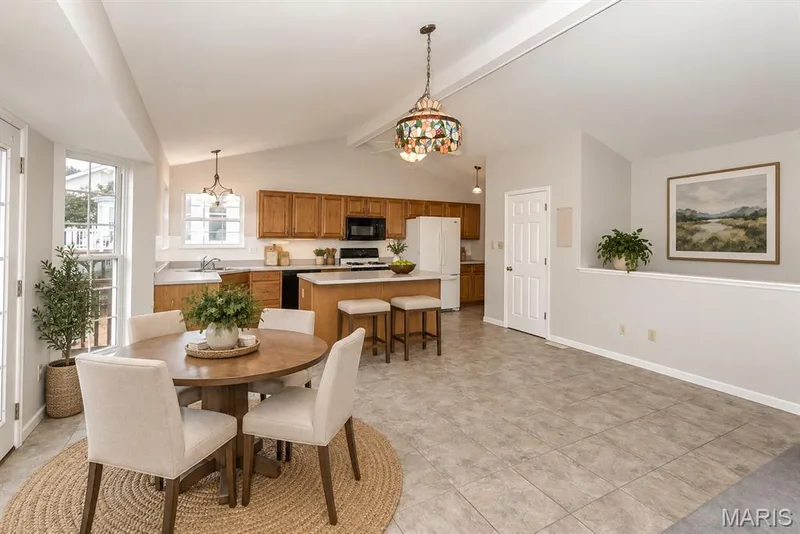Breakfast room is open to kitchen and great room, open stair to lower level  Virtually staged — 17027 Old Hollow Drive, Wildwood, MO 63040