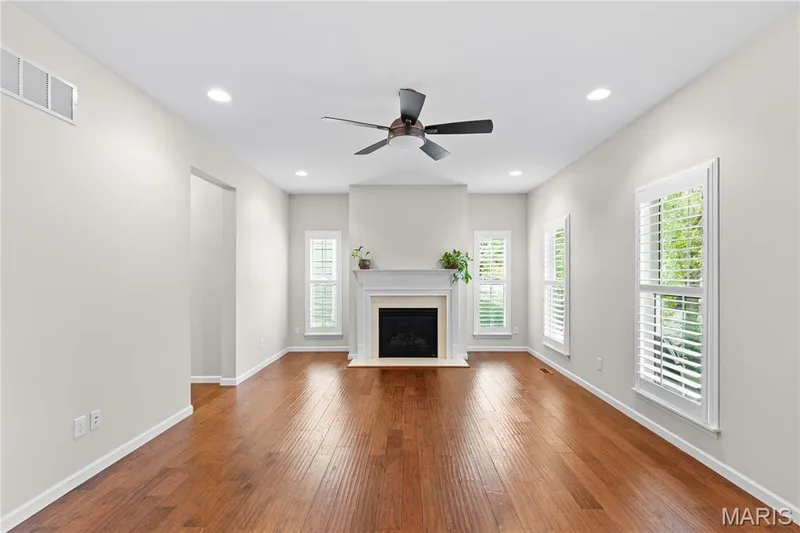 Hardwood-finish flooring, recessed lighting, and a ceiling fan — 3222 Starkville Street, St Charles, MO 63301