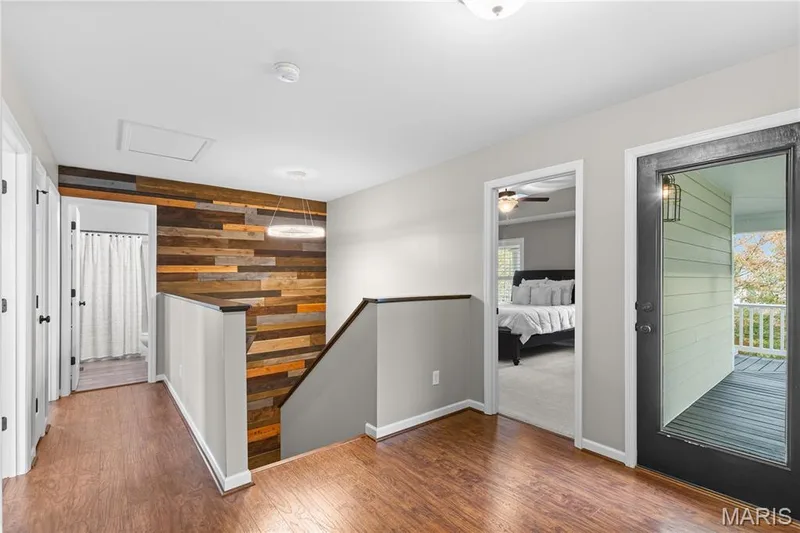 Wood-finish flooring throughout, complemented by a multi-tone wood accent wall — 3222 Starkville Street, St Charles, MO 63301