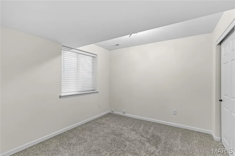Wall-to-wall carpeting with a light neutral tone — 3222 Starkville Street, St Charles, MO 63301