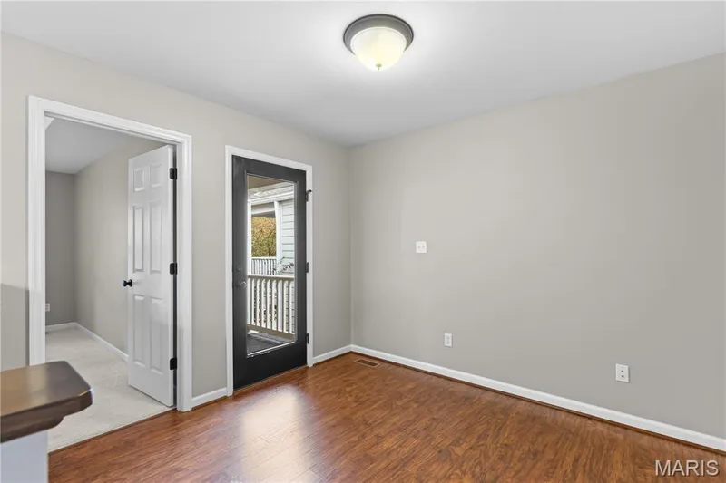 Wood-finish flooring, light gray wall paint, and a semi-flush mount ceiling light — 3222 Starkville Street, St Charles, MO 63301