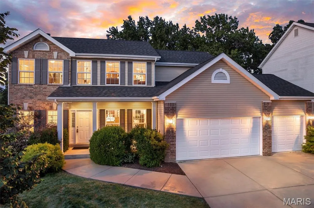 Brick and siding exterior, two-car garage, front entry porch, and mature landscaping — 1016 Gardenbridge Place, St Charles, MO 63303