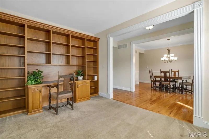 Built-in wood-finish shelving with integrated desk space — 1016 Gardenbridge Place, St Charles, MO 63303
