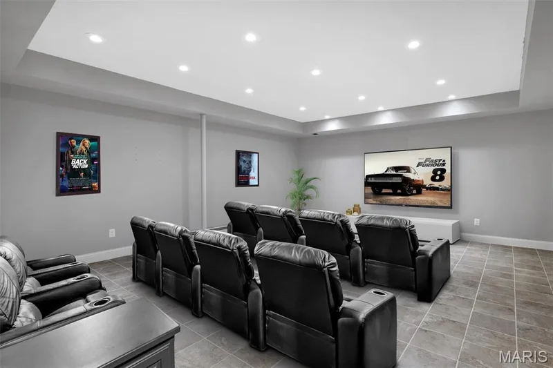 Recessed lighting, light gray wall paint, large flat-screen display, tiled flooring, and a drop ceiling — 1016 Gardenbridge Place, St Charles, MO 63303