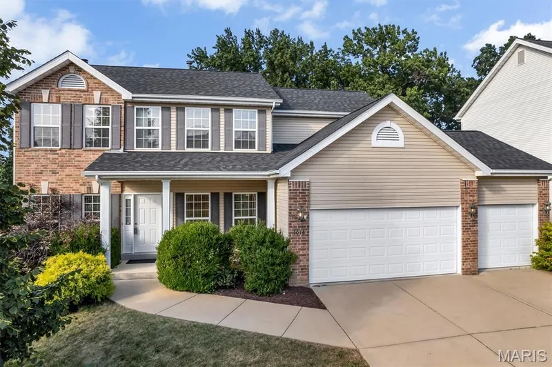 Brick and siding exterior with a dark shingled roof — 1016 Gardenbridge Place, St Charles, MO 63303
