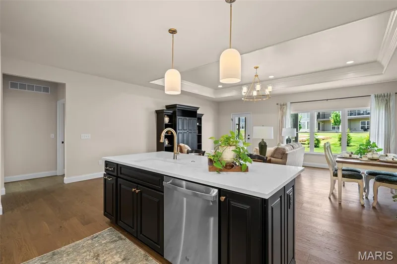 Kitchen island with white countertop, integrated sink, and stainless steel dishwasher — 193 Santa Elena Drive, Wentzville, MO 63385