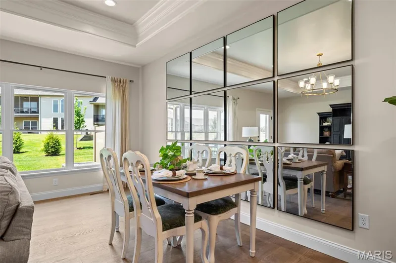 Recessed lighting, tray ceiling, wood-finish flooring, multiple pane windows, and an exterior green space — 193 Santa Elena Drive, Wentzville, MO 63385