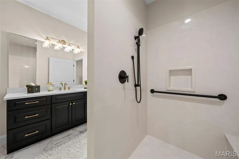 Black vanity with gold-finish hardware, white countertop, and gold-finish faucet — 193 Santa Elena Drive, Wentzville, MO 63385
