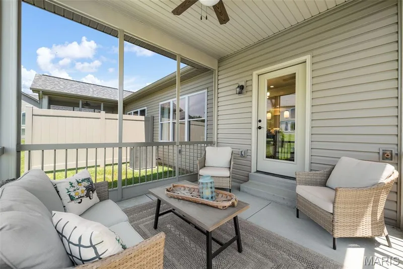 Screened-in porch with concrete flooring, a ceiling fan, and direct exterior access — 193 Santa Elena Drive, Wentzville, MO 63385