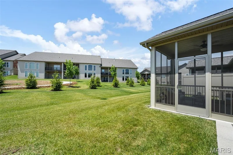 Expansive green space with a screened-in porch featuring a ceiling fan — 193 Santa Elena Drive, Wentzville, MO 63385