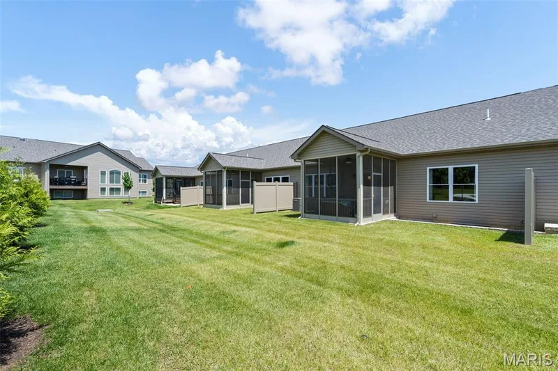 Expansive lawn space with structured landscaping and multiple screened-in porches — 193 Santa Elena Drive, Wentzville, MO 63385