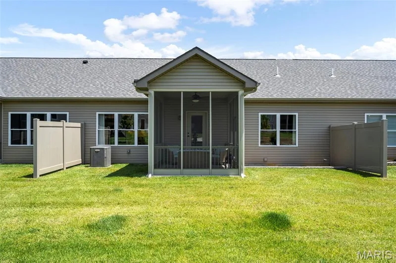 Screened-in porch with an attached ceiling fan, accompanied by a residential structure featuring siding and an asphalt shingle roof — 193 Santa Elena Drive, Wentzville, MO 63385