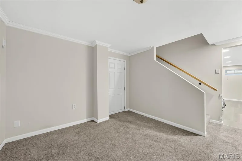 Rec room with door leading into unfinished part of basement for storage — 1941 Royal Heir Drive, O'Fallon, MO 63366