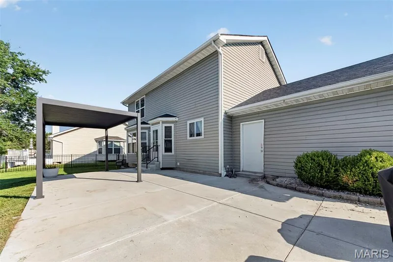 Patio has door that leads into the garage — 1941 Royal Heir Drive, O'Fallon, MO 63366