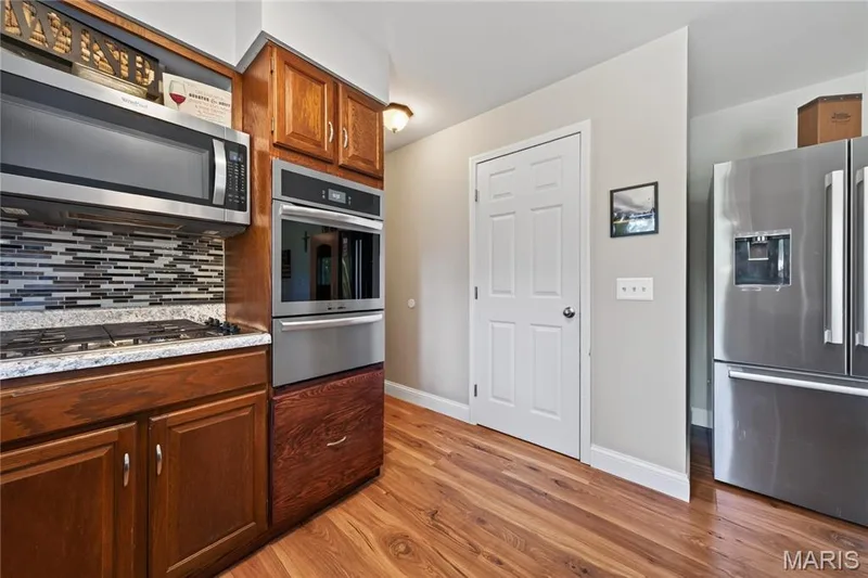 Kitchen has hardwood floors, walk in pantry — 72 Champagne Drive, Lake St. Louis, MO 63367