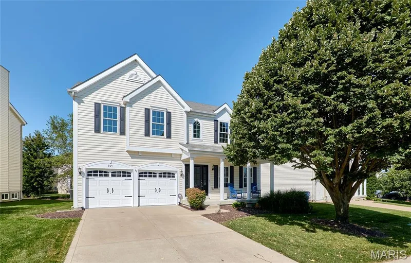 Classic two-story Colonial with crisp white siding and traditional architectural details — 264 Greenshire Lane, Dardenne Prairie, MO 63368