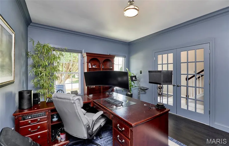 Sophisticated home office featuring perimeter blue-painted walls, recessed ceiling lighting, wood-finish flooring, and French doors with multi-pane glazing — 264 Greenshire Lane, Dardenne Prairie, MO 63368