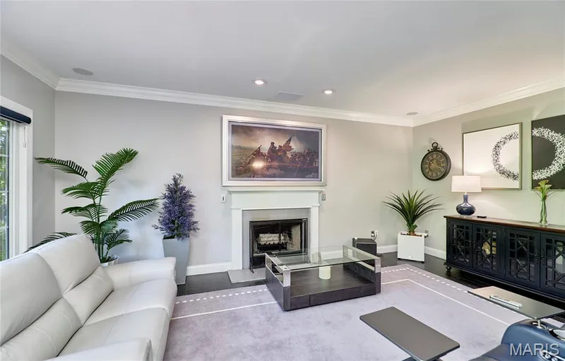 Fireplace with a white mantel, dark wood-finish flooring, recessed lighting, and crown molding — 264 Greenshire Lane, Dardenne Prairie, MO 63368