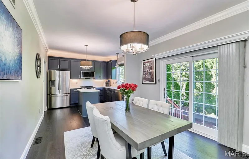 Kitchen with dark cabinetry, stainless steel appliances, and an island with a light-colored countertop — 264 Greenshire Lane, Dardenne Prairie, MO 63368