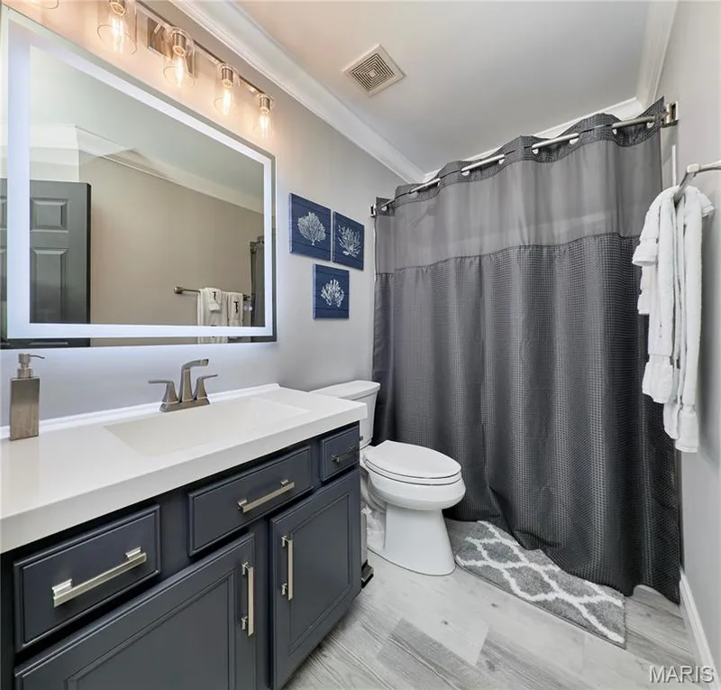 Spa-inspired primary bathroom featuring a floating vanity with dual-sink configuration, brushed nickel hardware, and quartz countertop — 264 Greenshire Lane, Dardenne Prairie, MO 63368