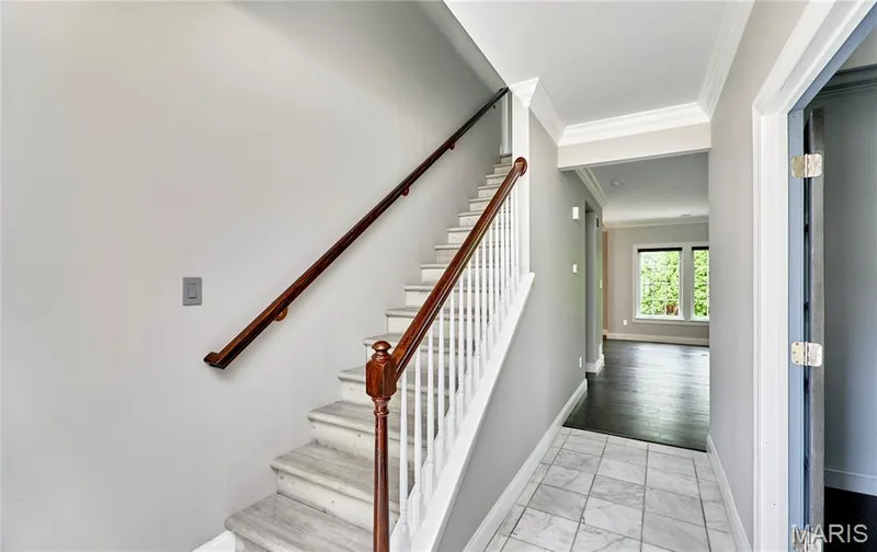 Staircase with wood banister and white balusters — 264 Greenshire Lane, Dardenne Prairie, MO 63368
