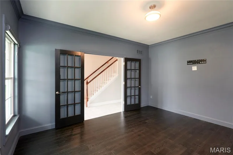 Wood-finish flooring, French doors with glass panes, crown molding, a flush mount ceiling light, and a double-hung window — 264 Greenshire Lane, Dardenne Prairie, MO 63368