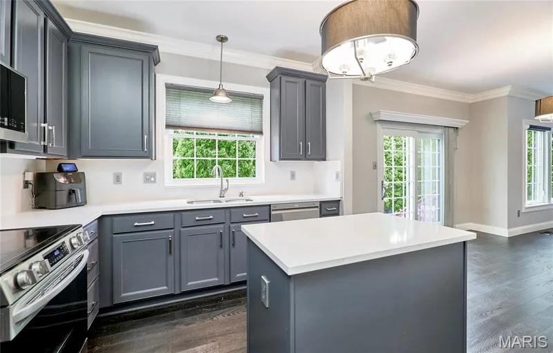 Kitchen featuring gray cabinetry, white countertops, stainless steel appliances, and wood-finish flooring — 264 Greenshire Lane, Dardenne Prairie, MO 63368