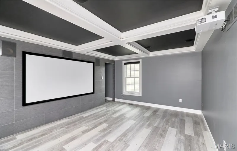 Coffered ceiling, wall-mounted projection screen, ceiling-mounted projector, integrated wall speakers, wood-finish flooring — 264 Greenshire Lane, Dardenne Prairie, MO 63368