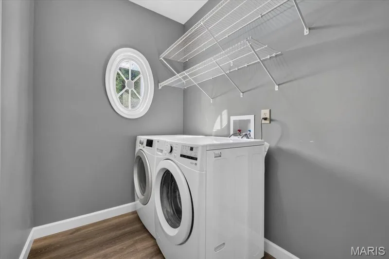 Convenient main floor laundry with shelving and natural. light — 3445 Riverchase Parkway, St Charles, MO 63301