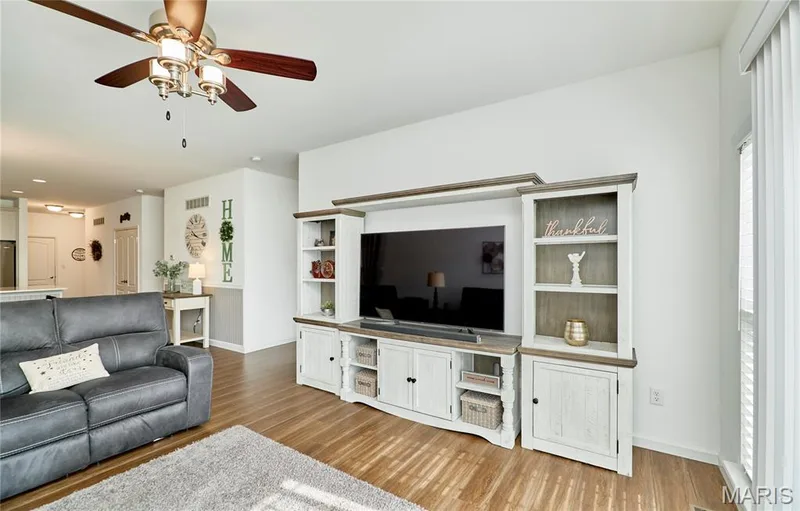 Wood-finish flooring with a ceiling fan overhead — 305 Copperfield Court, St Charles, MO 63301