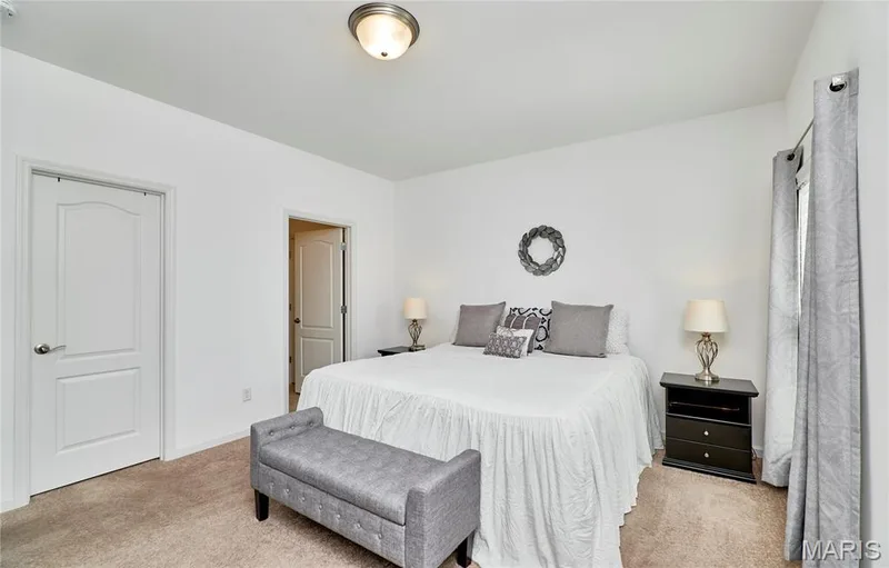 Neutral wall paint, textured carpet flooring, interior panel doors, and a ceiling-mounted light fixture — 305 Copperfield Court, St Charles, MO 63301