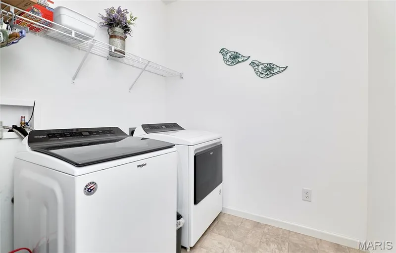 White walls, built-in wire shelving, and neutral-toned flooring — 305 Copperfield Court, St Charles, MO 63301