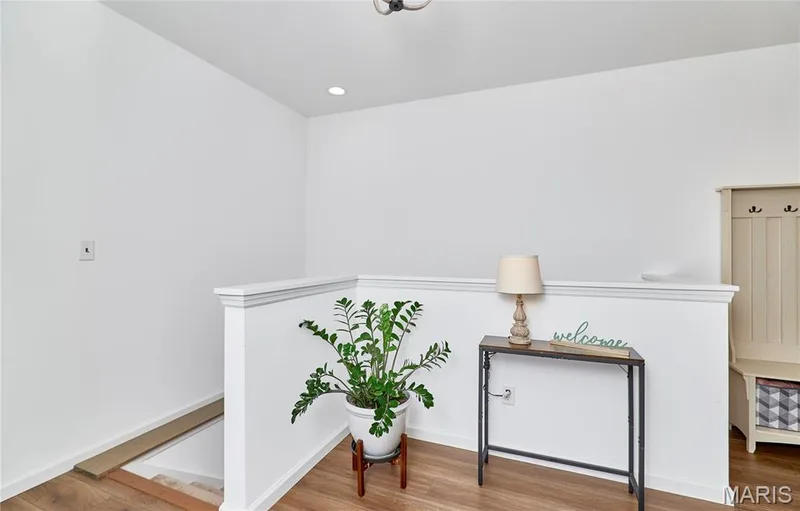 Wood-finish flooring with white wall trim and bright white walls — 305 Copperfield Court, St Charles, MO 63301