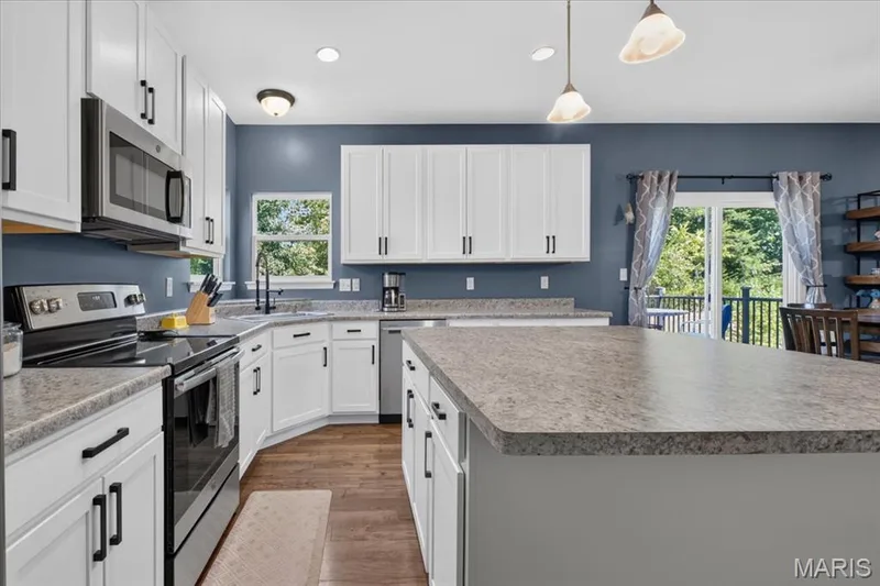 Tons of cabinets and a huge island in this kitchen — 634 Creek Bend Drive, Lake St. Louis, MO 63367