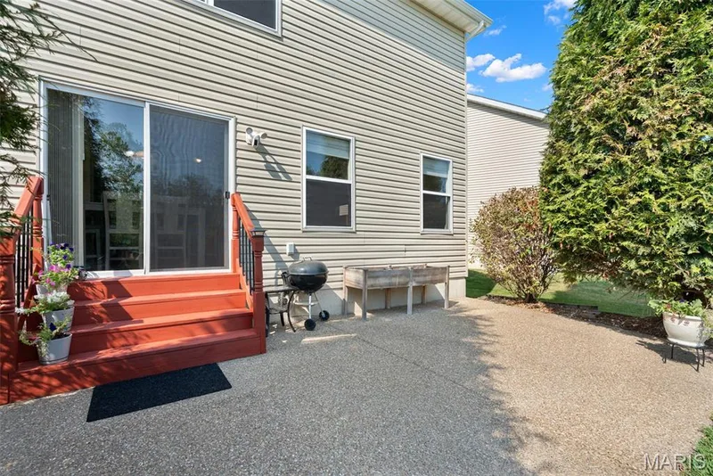 Patio sliding doors leading to the freshly stained deck and back yard — 166 Brushy Brook Drive, O'Fallon, MO 63366