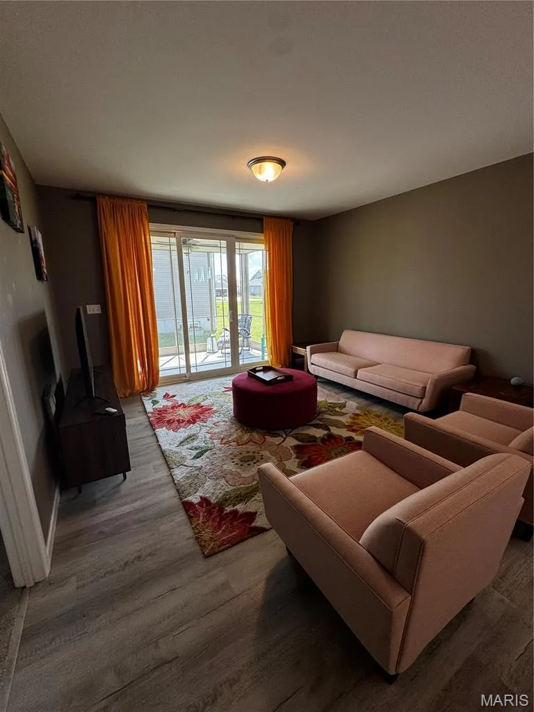 Wood-finish flooring throughout, complemented by a ceiling-mounted light fixture — 401 Copperfield Court, St Charles, MO 63301