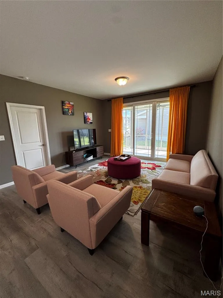 Wood-finish flooring, recessed lighting, sliding glass door, and a flush-mount ceiling fixture — 401 Copperfield Court, St Charles, MO 63301
