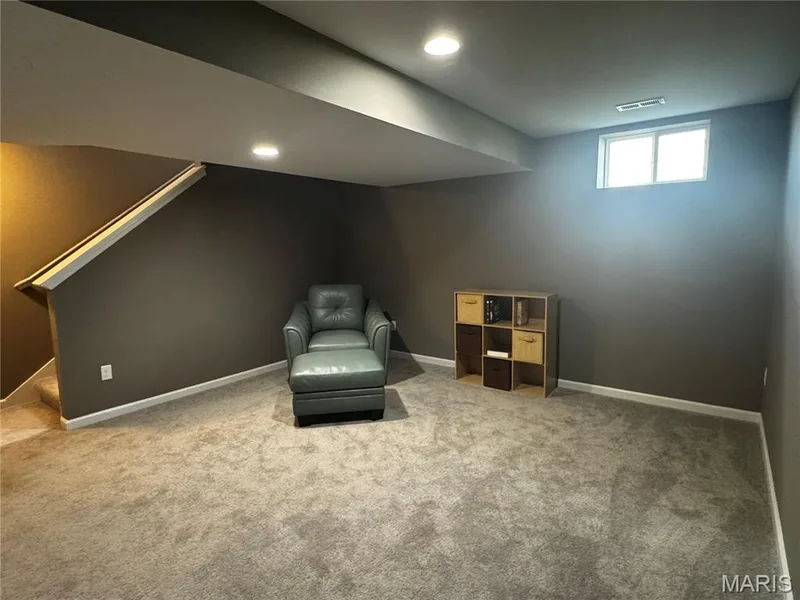 Recessed lighting, wall-to-wall carpeting, and a window provide illumination — 401 Copperfield Court, St Charles, MO 63301