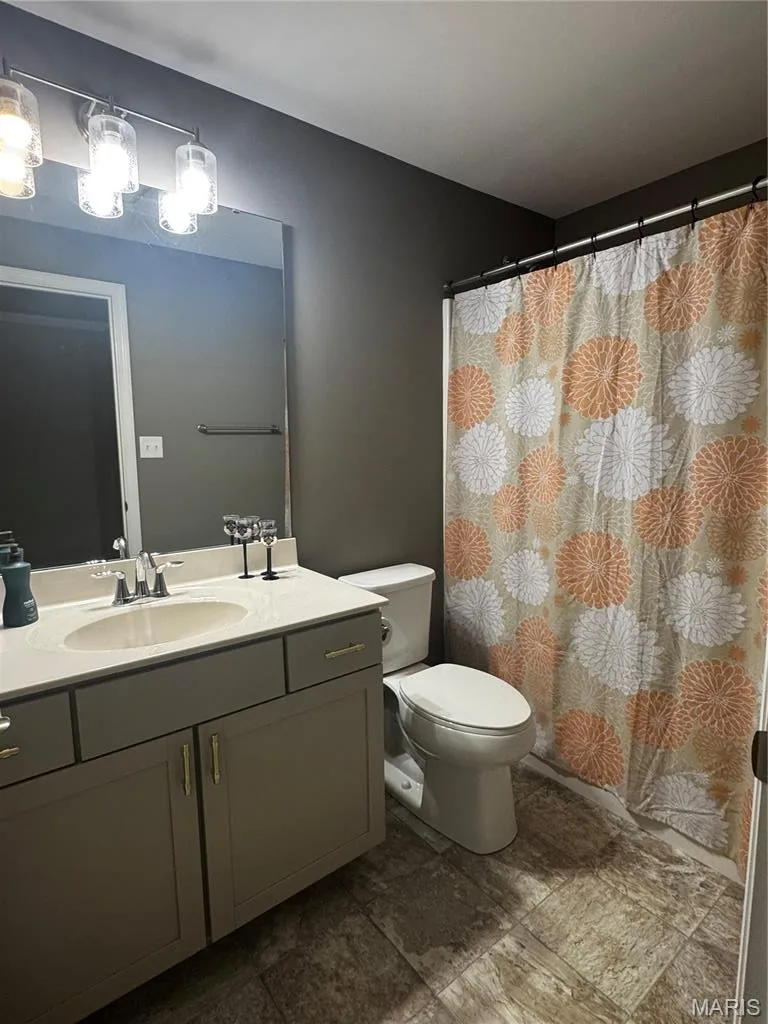 Vanity with an integrated sink, brushed nickel faucet, and under-counter storage — 401 Copperfield Court, St Charles, MO 63301