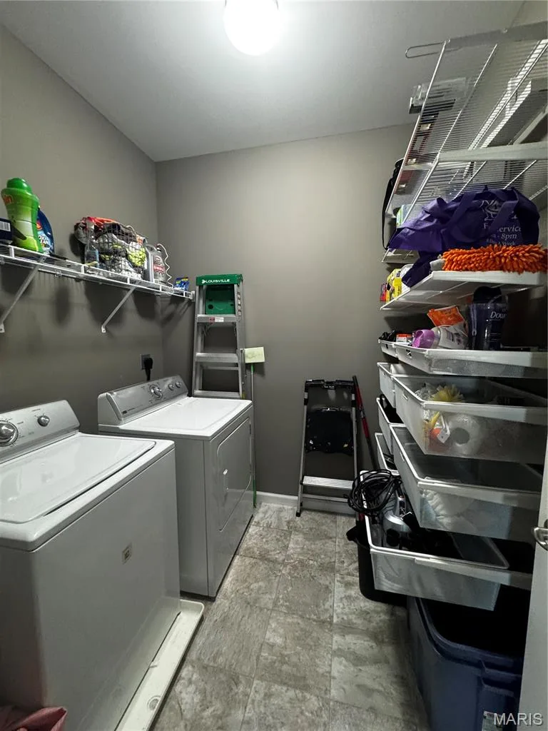 Utility room featuring permanent wire shelving units, a ceiling-mounted light fixture, and tile-finish flooring — 401 Copperfield Court, St Charles, MO 63301