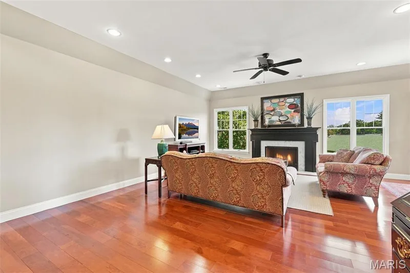 Handsome gas fireplace flanked by windows.  9' Ceilings in several rooms — 208 Ambridge Court #303, Chesterfield, MO 63017